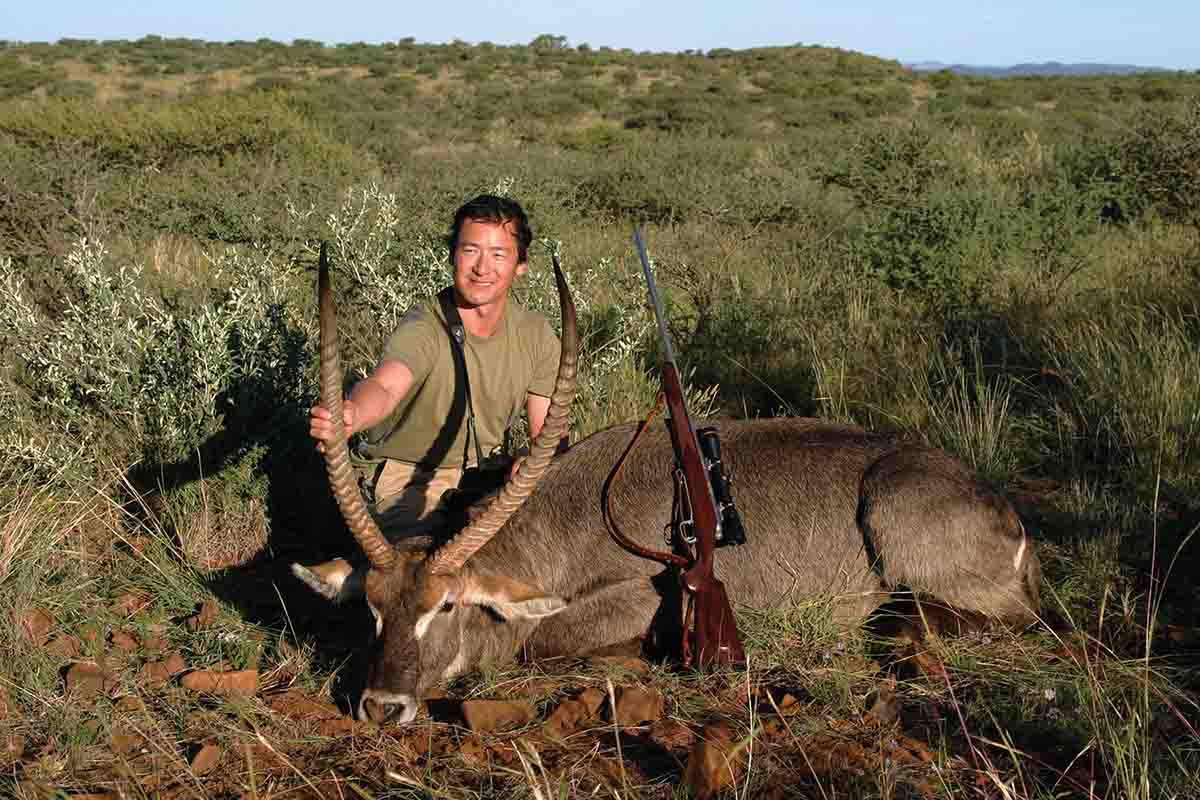 The .338 does not recoil nearly as much as many hunters believe, especially with lighter controlled-expansion bullets. Charlie Sonu used his Kilimanjaro Rifles .338 with Nosler 225-grain AccuBonds to take a dozen animals, including blue wildebeest, gemsbok, zebra and this waterbuck, mostly with one shot each.